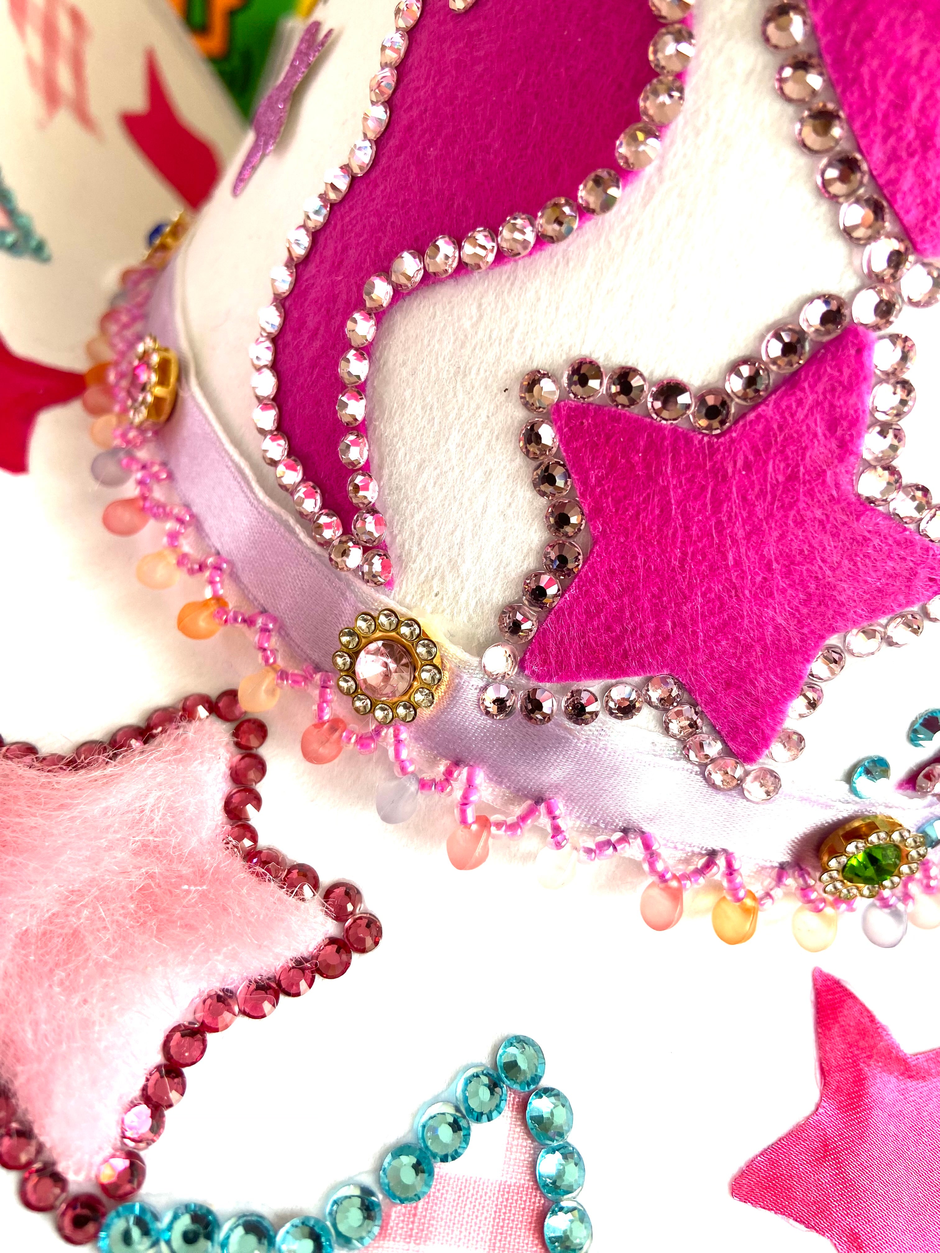 Close up of White Custom Cowboy Hat with a Pink Fluffy Star