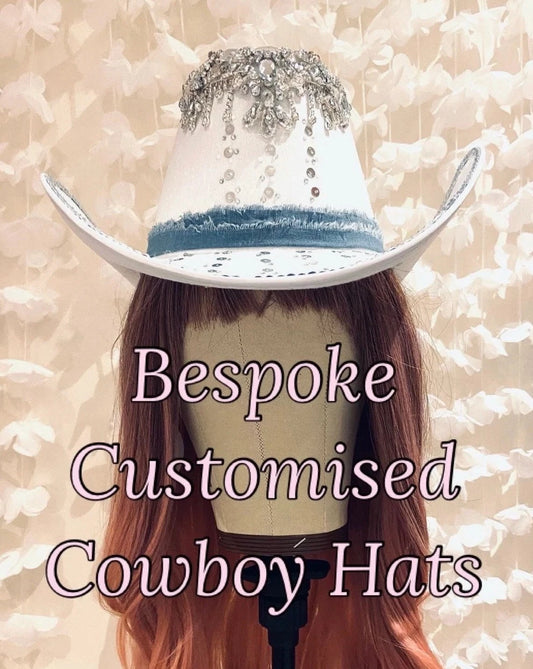 White custom cowboy hat for torn denim band and silver vintage jewellery on the peak